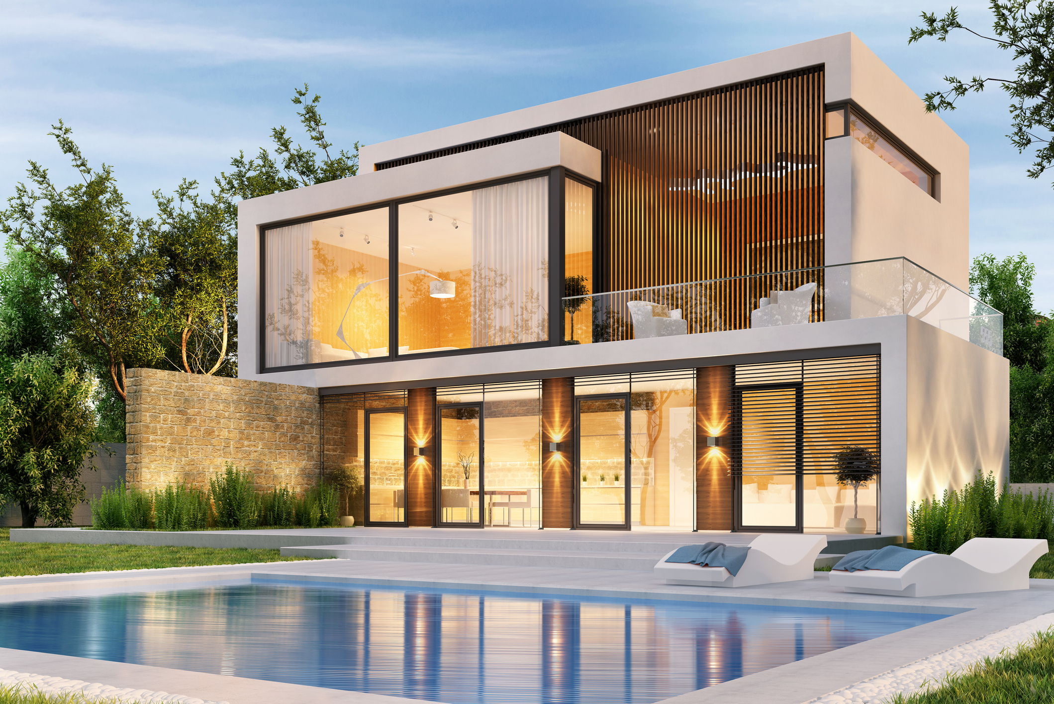 Evening view of a modern large house with swimming pool