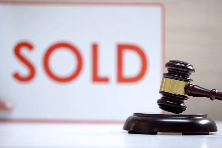 Gavel standing sound block against sold sign background, court decision, auction