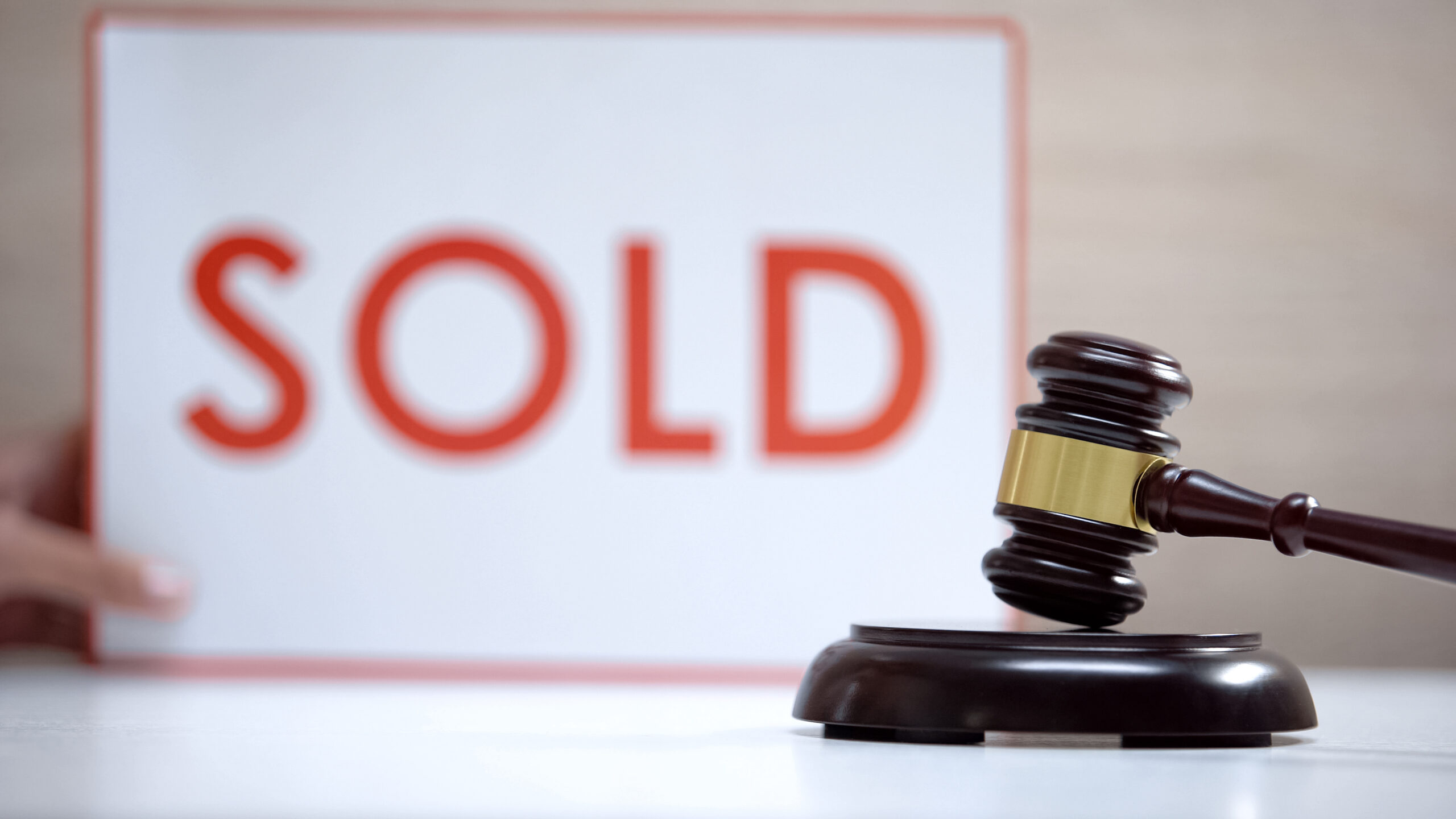 Gavel standing sound block against sold sign background, court decision, auction